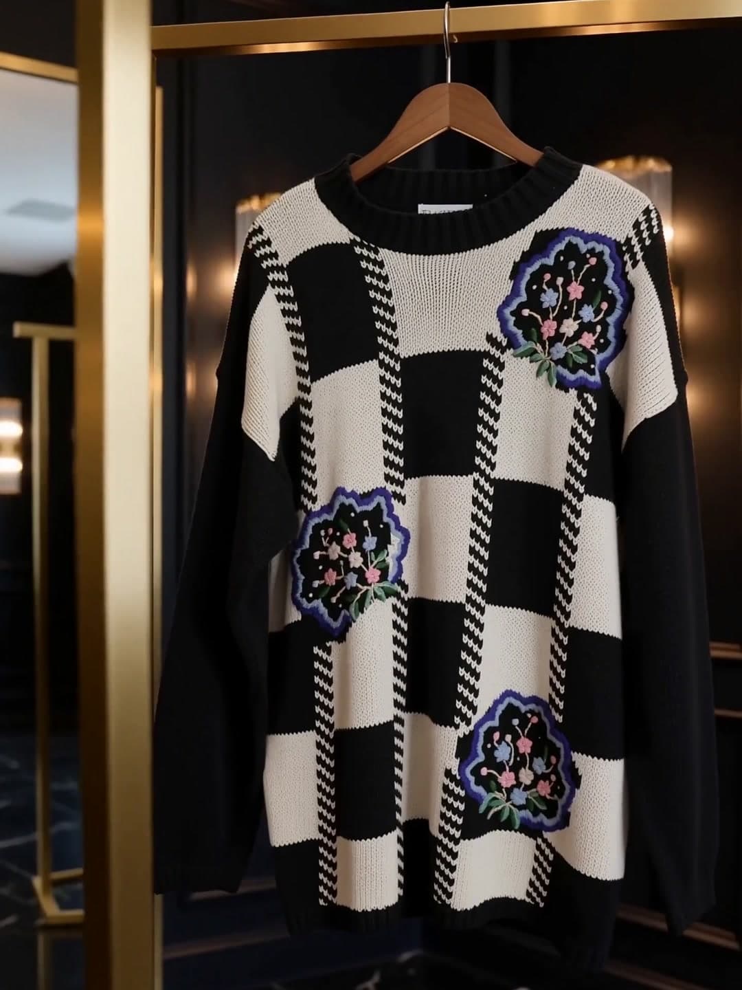 Floral check knit hanging on a gold rail